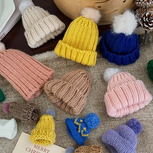 Colorful knitted Christmas mini hats set with fur pompoms for festive tree decorations