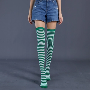 Detailed view of green and white striped over-knee socks in high-quality knitted cotton