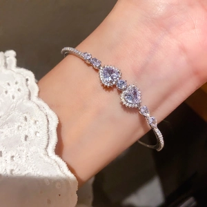 Close-up of sparkling heart-shaped purple zircon bracelet with micro-pave crystals