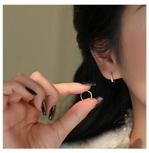 Close-up of minimalist S925 sterling silver hoop earrings with sparkling zircon accents