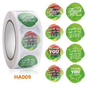 Macro view of floral watercolor Thank You stickers in roll form for gift sealing