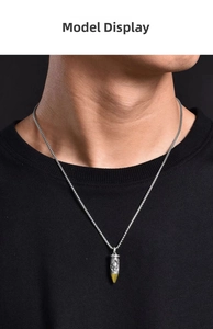 Detailed close-up of a punk-style skull bullet pendant with silver and gold accents