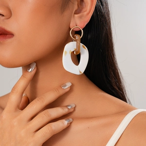 Six-piece earring set featuring diamond-set acrylic hearts and geometric metal rings on a model