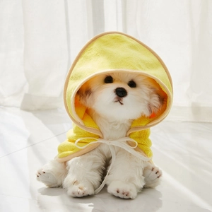 Detail of yellow microfiber pet bathrobe with soft texture and white ribbon bow tie