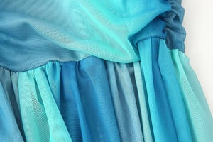 Macro del tessuto a rete con sfumatura blu e dettagli plissettati del vestito