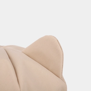 Close-up of beige twill cotton octagonal hat fabric showing cute cat ear detail