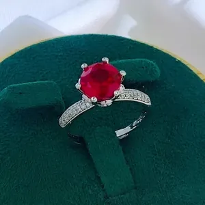 Macro shot of a classic six-prong setting ring with a deep red round-cut gemstone