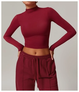 Detail of burgundy high-neck long sleeve compression top and matching drawstring joggers set