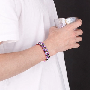 Close-up of rainbow iridescent Cuban link bracelet on wrist with thick metal texture