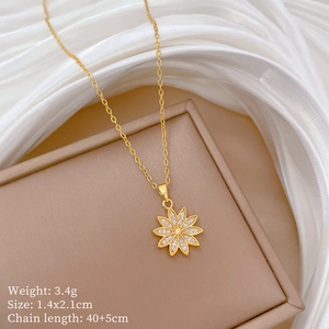 Detail of gold daisy pendant with cubic zirconia and size specs 1.4x2.1cm on chain