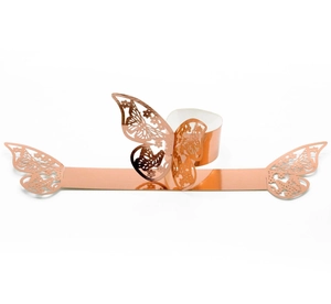 Macro detail of laser-cut rose gold butterfly napkin ring with hollow metal craftsmanship