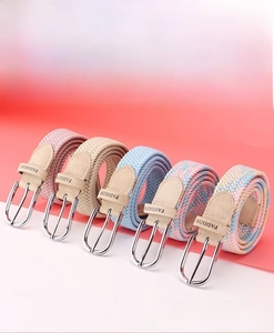 Detail view of woven elastic belts in five colors with silver buckles and leather accents