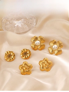 Detailed macro view of 18K gold-plated floral earrings featuring pearls and textures