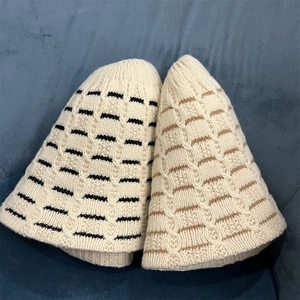 Women's cable-knit wool bucket hats in beige with black and brown stripe accents