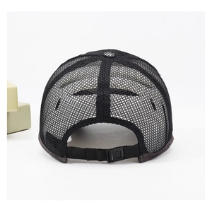 Detail view of the breathable black mesh back and adjustable buckle strap on the baseball cap