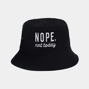 Detail of white NOPE. not today embroidery on black cotton sun hat with air vents
