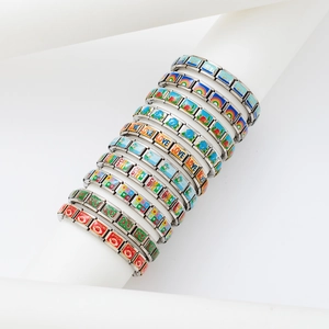 Italian charm bracelets on white display showing colorful enamel icons and engraved links