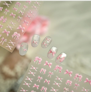 Detailed 3D pink bow nail stickers with pearls and ribbons for coquette style manicure