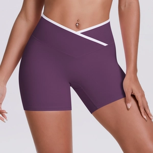 Detail of high-waist yoga shorts featuring white V-shaped crossover contrast waistband
