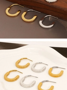 Detailed display of U-shaped stainless steel earrings in gold and silver finishes