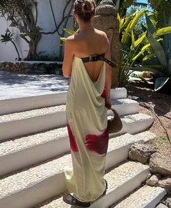 Detail of backless maxi dress with black buckle strap and red abstract print