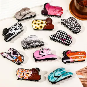 Flat lay of Western cowboy hat and boot hair claws with leopard and cow prints