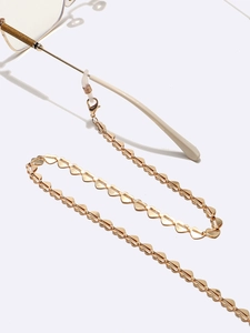 Golden heart-shaped metal glasses chain with lobster clasp on a clean white background
