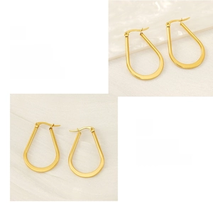 Detailed shot of polished and gold-plated U-shaped stainless steel earrings texture