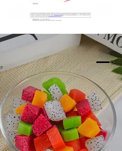 Detailed close-up of realistic PVC fruit cubes including dragon fruit and kiwi in a glass bowl
