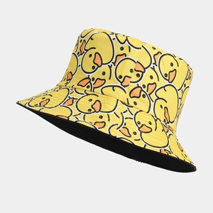 Yellow bucket hat featuring cartoon duck prints with a contrasting black inner brim lining