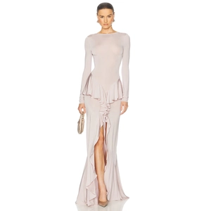Detail of elegant ruffled hem and high side slit on the light pink slim fit maxi dress