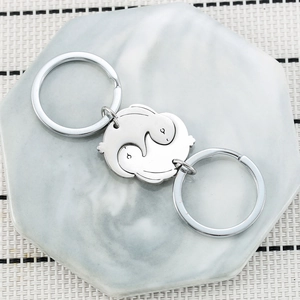 Macro detail of interlocking stainless steel rabbit keychains on hexagonal base