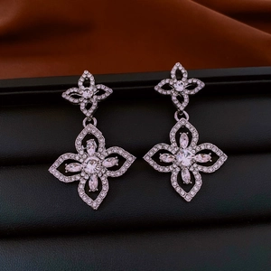 Detailed close-up of crystal flower drop earrings with silver plating and zircon stones
