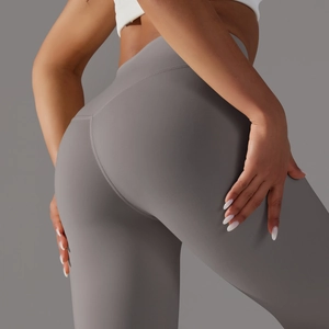 Detail view of high waisted grey yoga pants featuring slimming back seam and matte fabric