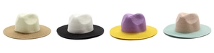 Detail of four bicolor straw panama hats showing textured weave and contrast brims