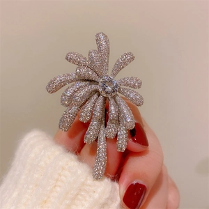 Elegant silver firework brooch with sparkling zircons and a large central diamond core