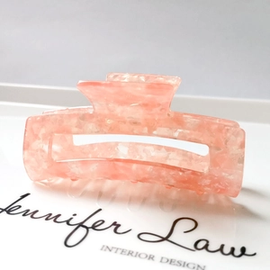 Close-up of pink marble acetate hair claw clip showing natural texture and smooth teeth