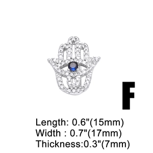 Macro shot showing dimensions of silver Hamsa charm with blue evil eye and zircon stones