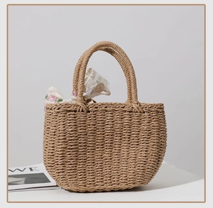 Close-up of beige woven straw tote bag with floral silk scarf handle detail