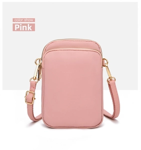 Pink mini crossbody phone bag with double zipper and adjustable strap hardware details