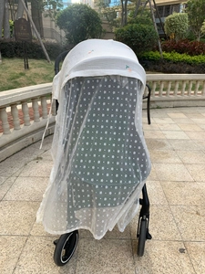 Detail of white cotton stroller sunshade with flower embroidery and breathable mesh netting