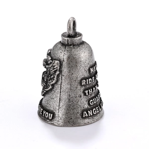 Close-up of vintage biker guardian bell with engraved angel wings and relief text