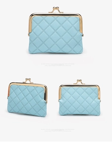 Detail view of light blue quilted coin purse with gold clasp and faux leather texture