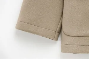 Detailed close-up showing precision stitching and wool blend texture of the khaki coat