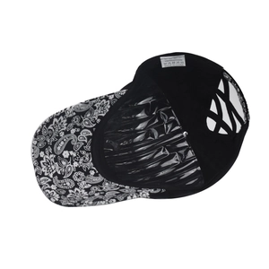 Detail of black baseball cap featuring paisley brim and elastic criss-cross ponytail back