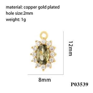 Macro detail of 18K gold plated copper oval pendant with olive green cubic zirconia
