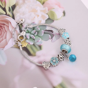 DIY silver snake chain bracelet with blue glass beads and angel wing pendants