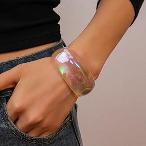 Detail of chunky iridescent acrylic bangle showing rainbow reflections and resin texture