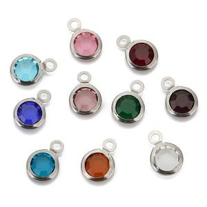 Macro display of colorful 8mm round zircon pendants with polished silver metal edges