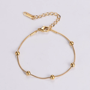 Detailed view of golden bead stainless steel bracelet with adjustable lobster clasp